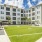 Interior courtyard at Rosalia Winter Park apartments in Winter Park, FL, featuring outdoor games, chairs, and palm trees.
