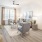 Model living room at Rosalia Winter Park apartments in Winter Park, FL, featuring wood grain flooring and large windows.