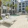 lounge chairs and tables next to pool and jacuzzi