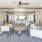 large covered outdoor patio with ceiling fans, tables and chairs