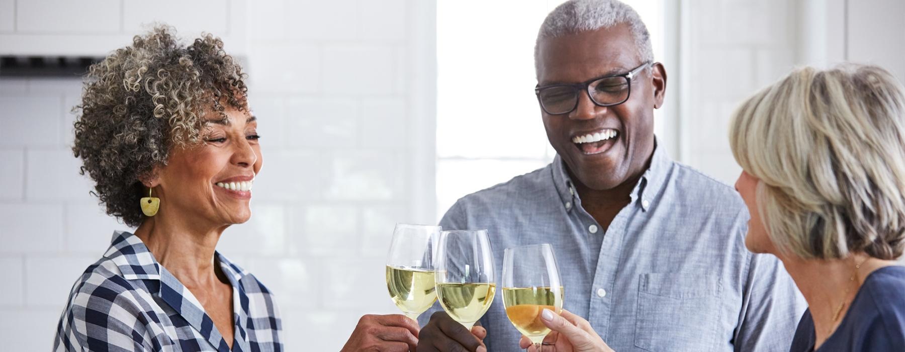 a few people toasting wine glasses