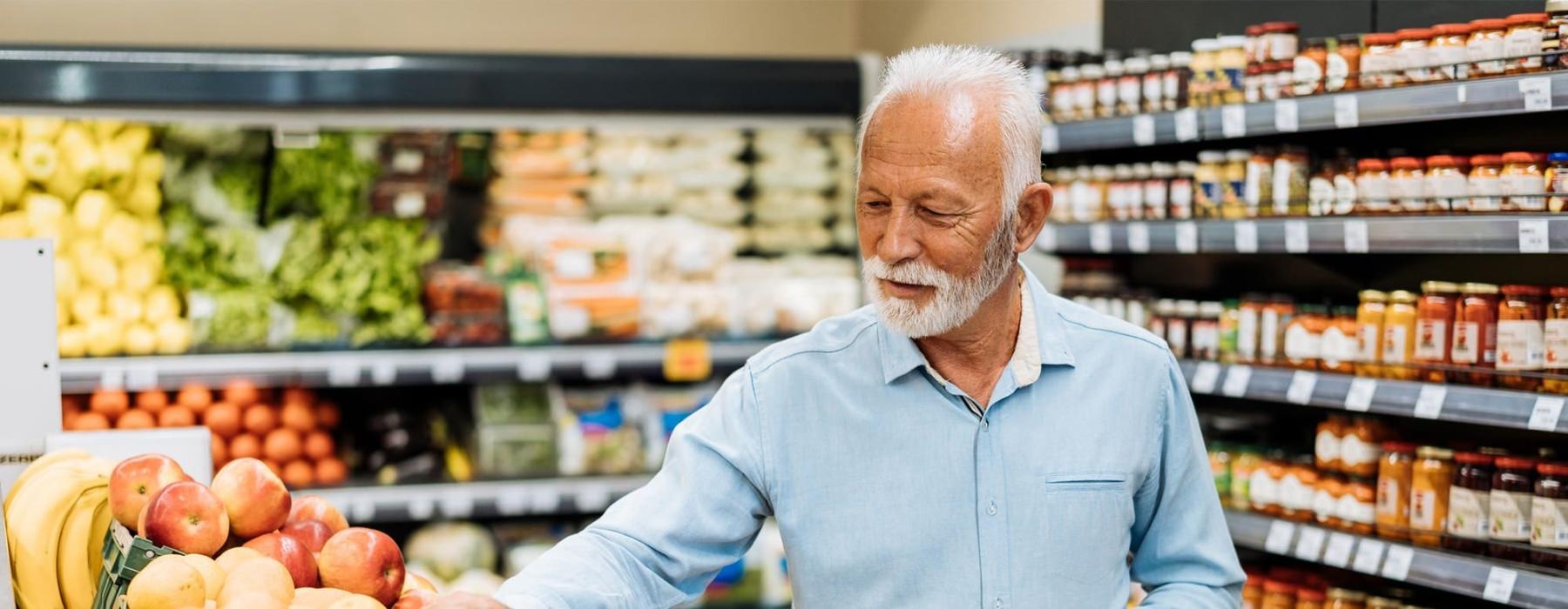 a person holding a shopping cart in a grocery store